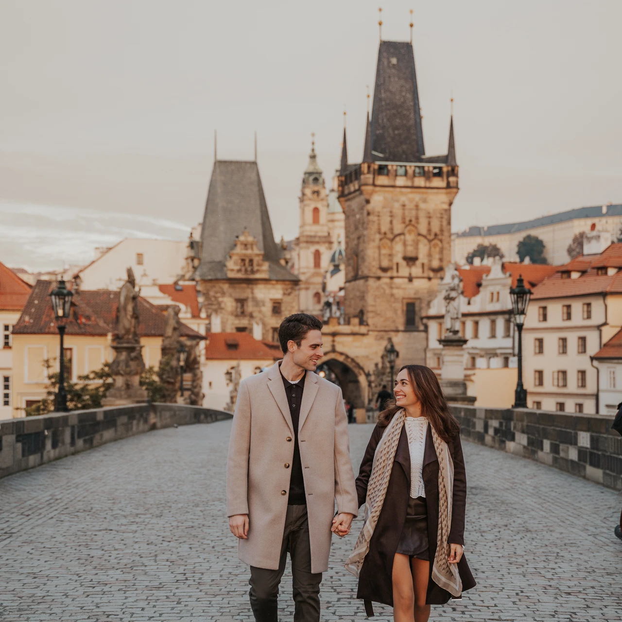 A couple holding hands during a photo session in Prague.